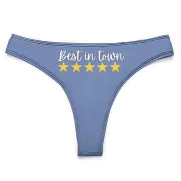 This image features a light blue women's thong that boasts a playful and charming design. The thong has the phrase "Best in town" printed across the front, accompanied by five yellow stars, adding a humorous touch to the garment.